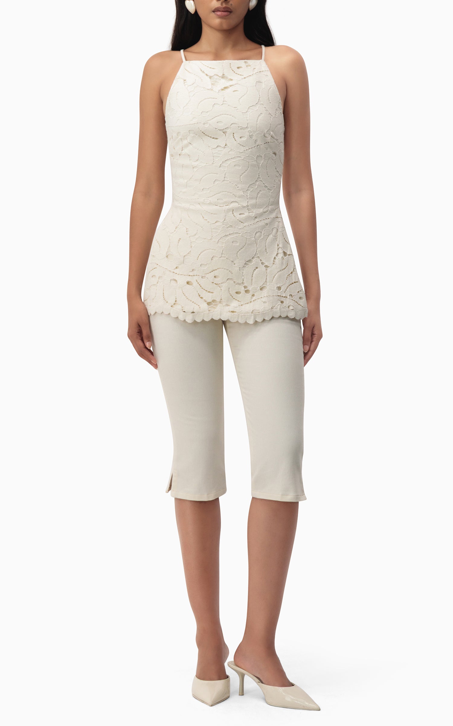 "Model wearing Junie Capri off‑white denim capris front view with fitted silhouette"