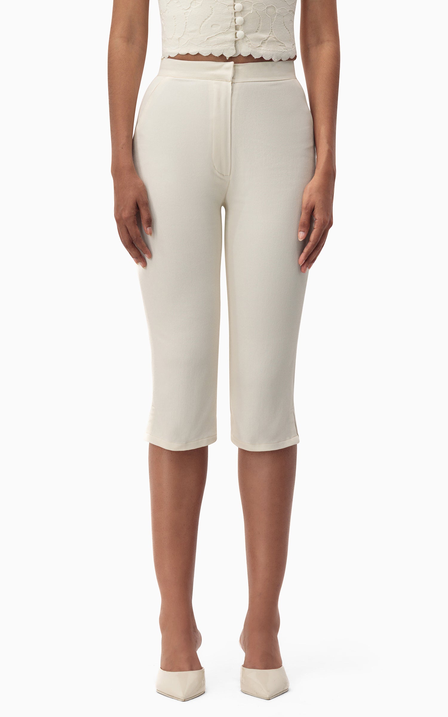 "Model wearing Junie Capri off‑white denim capris front view with fitted silhouette"